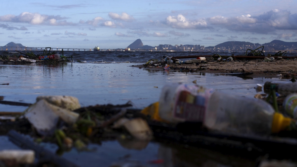 Concerns about pollution in the waters around Rio have prompted the world sailing federation to take action ahead of next year's Olympic Games. Here garbage is seen Bica Beach on the banks of the Guanabara Bay with the Sugar Loaf mountain in backg