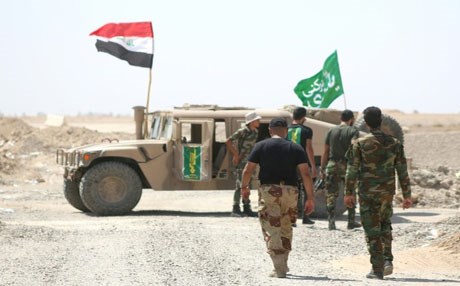 Members of the Popular Mobilisation units gather around a vehicle during a military operation against Islamic State group jihadists north of Fallujah