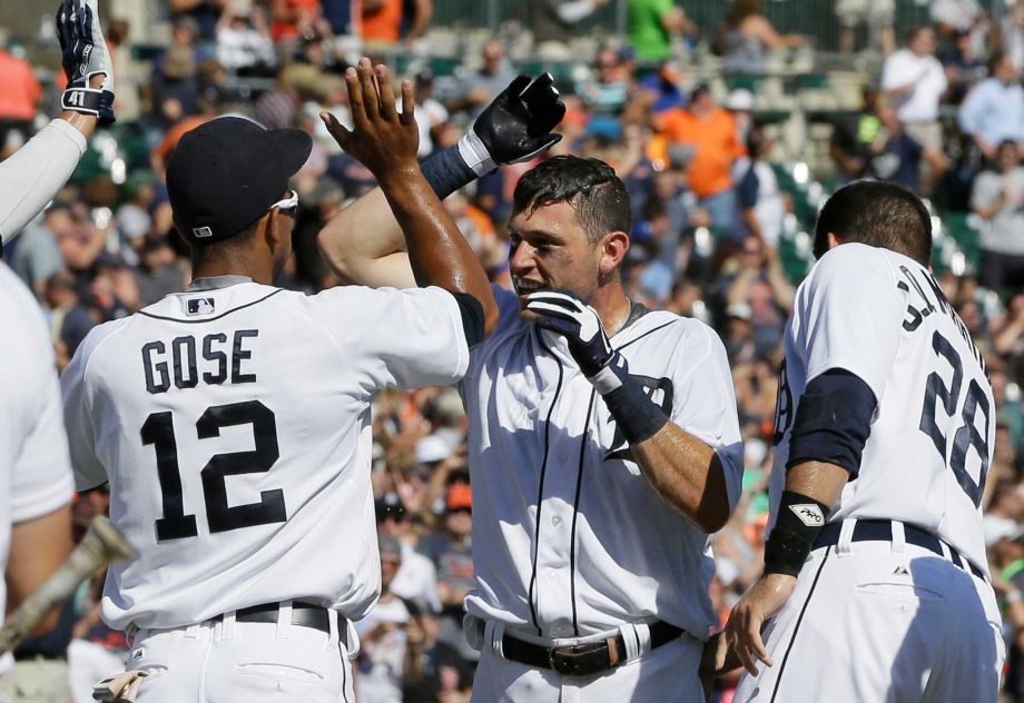 Detroit Tigers Ian Kinsler center is congratulated by teammate Anthony Gose and J.D. Martinez after his two-run walk-off home run off Kansas City Royals relief pitcher Ryan Madson during the ninth inning of a baseball game Thursday Aug. 6 2015 in D