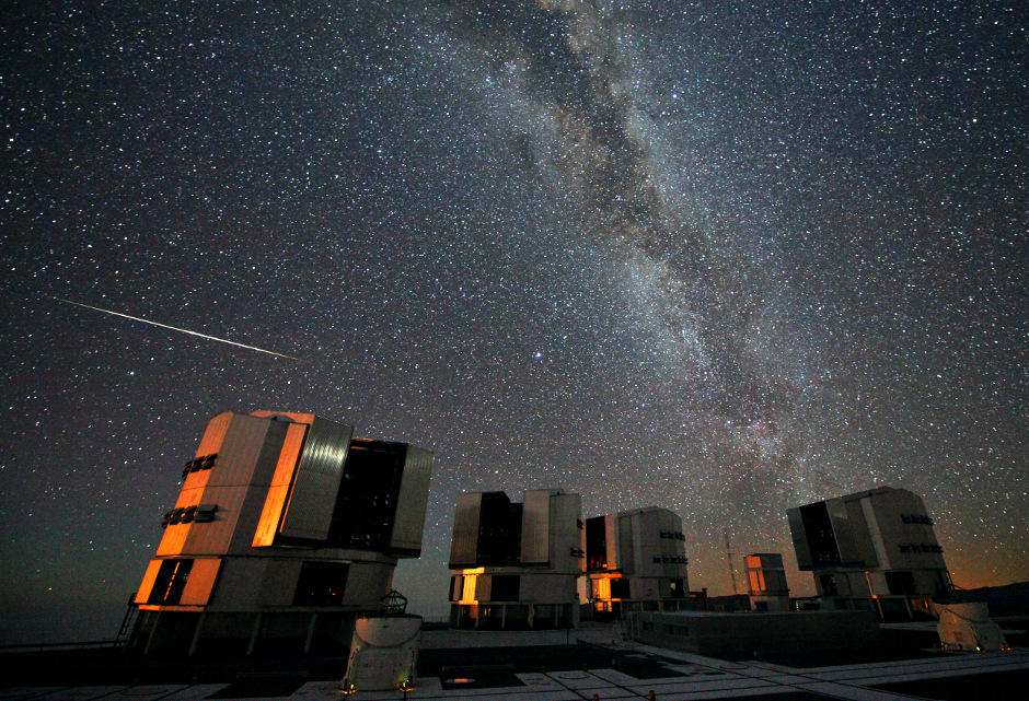 A Perseid meteor seen in August 2010 above the four enclosures of the European Southern Observatory’s Very Large Telescope at Paranal Chile. Image credit ESO  S. Guisard