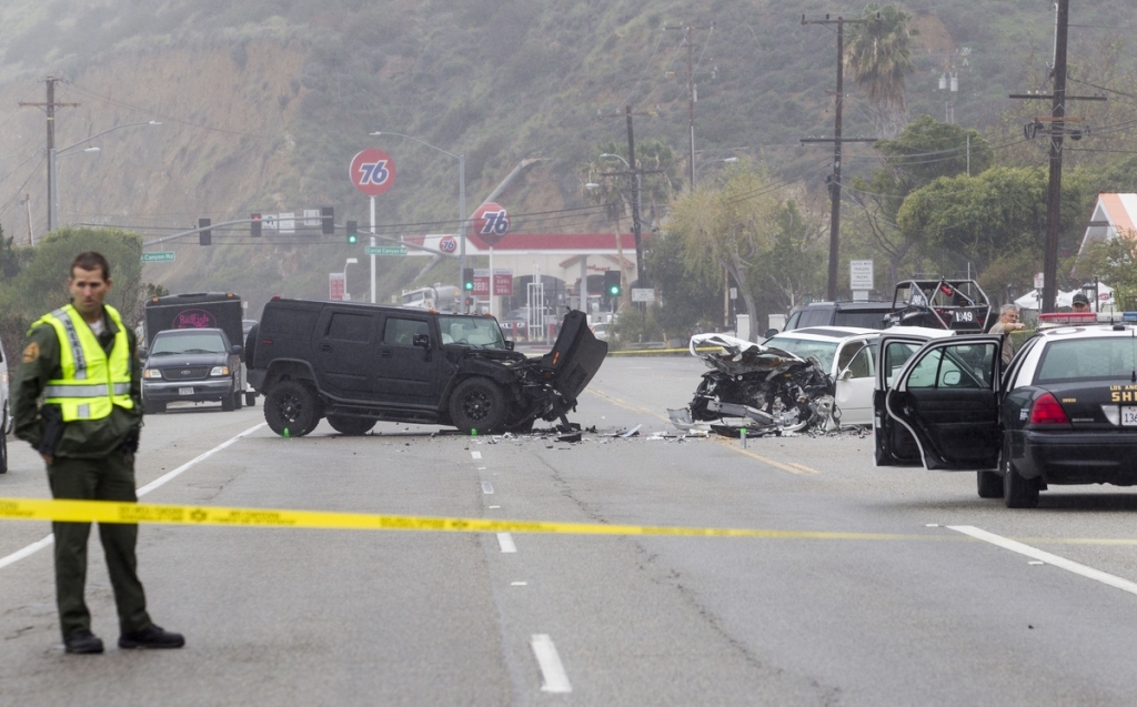 Los Angeles County Sheriff's deputy guards the scene of a collision involving three vehicles in Malibu Calif Sheriff's investigators plan to recommend prosecutors file a vehicular manslaughter charge against Caitlyn Jenner for