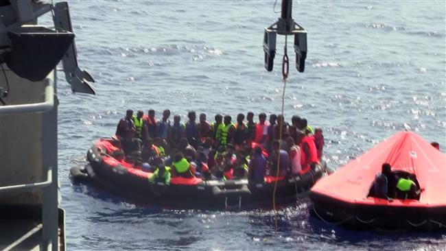 People in life rafts are seen during a rescue operation after their overcrowded fishing vessel capsized in the Mediterranean Sea off the coast of Libya