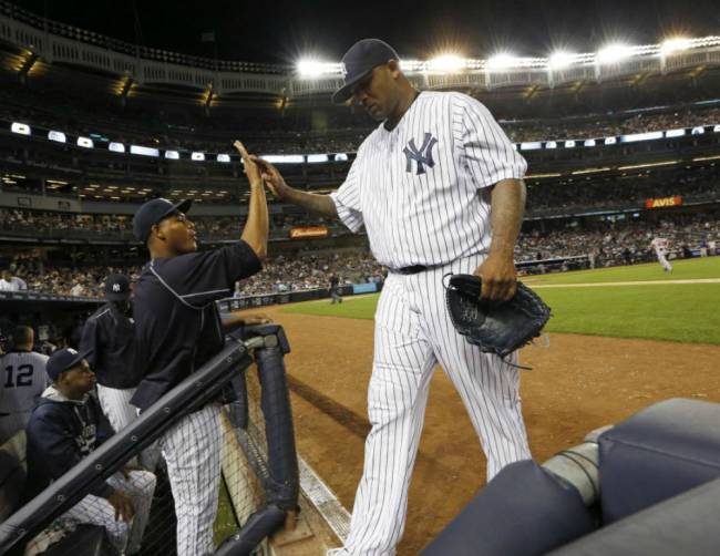 Yankees starting pitcher Ivan Nova left greets New York Yankees starting pitcher CC Sabathia after Sabathia left the mound at the end of the sixth inning