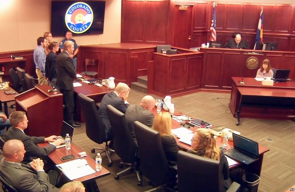 In this image taken from video accused Colorado theater shooter James Holmes standing on the far left listens as the verdict is read during his trial in Centennial Colorado