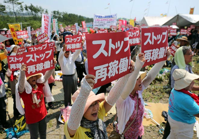 Anti-nuclear protesters holding a rally against the restart of a nuclear reactor in front of the Kyushu Electric Power Sendai nuclear power plant in Satsumasendai Kagoshima prefecture on Japan’s southern island of Kyushu. — AFP