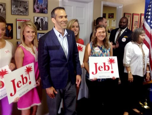 Texas Land Commissioner George P. Bush third from the left poses with supporters after turning in paperwork with the South Carolina Republican Party that will formally put his father Jeb's name on the state's 2016 presidential ballot on Friday July 31