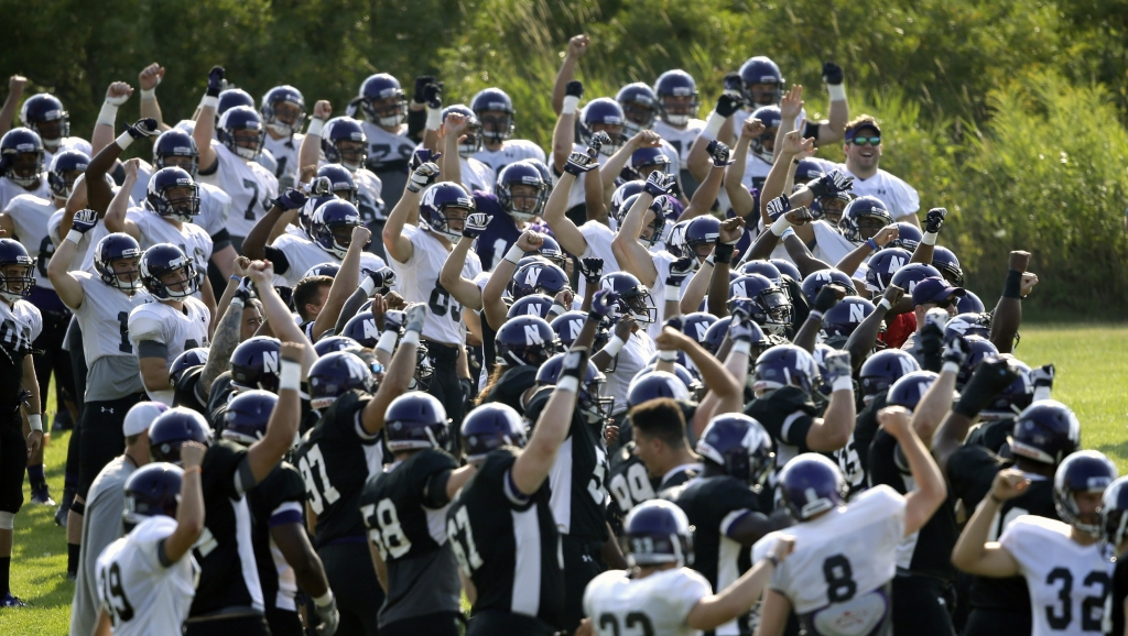 Northwestern football players run through drills at practice on Monday