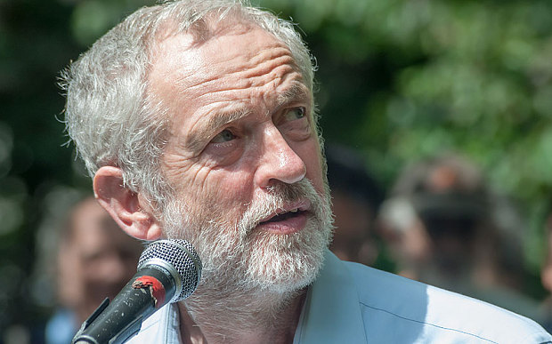 Jeremy Corbyn MP makes an atypically expansive gesture at the end of his speech to the annual commemoration of the dropping of the atomic bomb on Hiroshima 6th August 2015