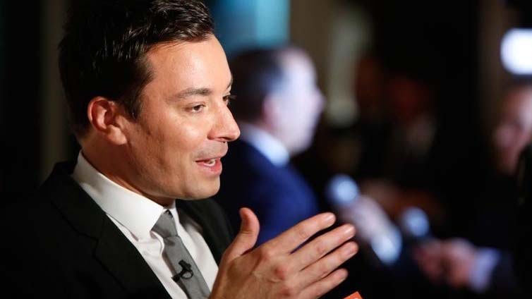 Television show host Jimmy Fallon talks to reporters on the red carpet for the taping of the Mark Twain Prize for Humor ceremony and performance at the Kennedy Center in Washingt