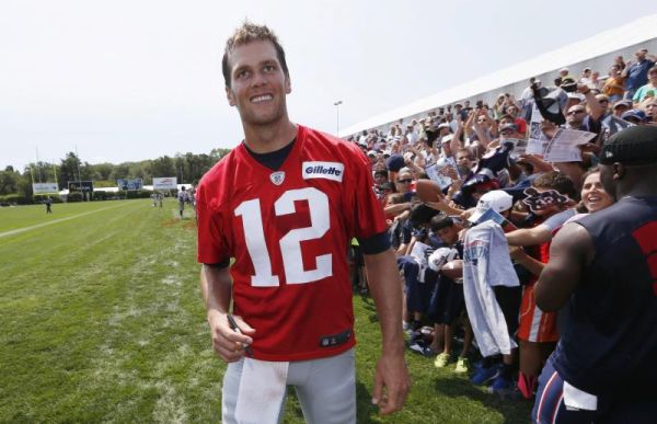 New England Patriots quarterback Tom Brady walks down