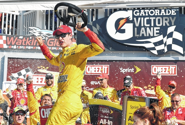 Joey Logano celebrates in Victory Lane after winning a NASCAR Sprint Cup race at Watkins Glen International Sunday in Watkins Glen. N.Y. AP