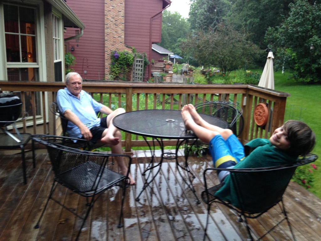 John Carpenter aka Grampa Jack and his 12-year-old grandson enjoy the rain in a Chicago