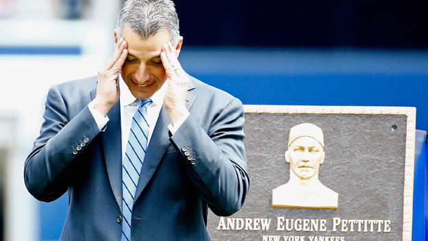 Former Yankees pitcher Andy Pettitte stands next to his retired plaque which will go into Monument Park at Yankee Stadium