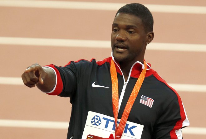 Silver medalist Justin Gatlin of the United States points to the crowd during the medal ceremony for the men ™s 100m final at the World Athletics Championships at the Bird's Nest stadium in Beijing Monday Aug. 24 2015