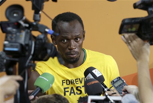 Jamaica's Usain Bolt is interviewed after winning the gold medal in the men's 100m at the World Athletics Championships at the Bird's Nest stadium in Beijing Sunday Aug. 23 2015