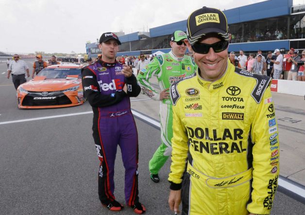 Matt Kenseth right walks away after talking with Denny Hamlin left and Kyle Busch center after qualifying Friday Aug. 14 2015 for the pole position for the NASCAR Sprint Cup series auto race at Michigan International Speedway in Brooklyn Mich. P