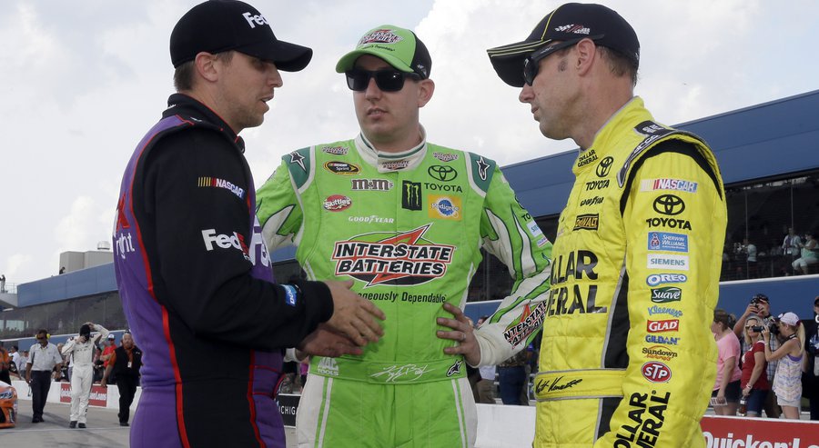 Denny Hamlin left talks with Kyle Busch center and Matt Kenseth after qualifying Friday Aug. 14 2015 for the NASCAR Sprint Cup series auto race at Michigan International Speedway,in Brooklyn Mich. Kenseth won the pole