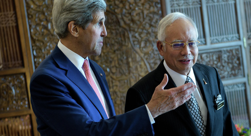 Malaysia’s Prime Minister Najib Razak listens while US Secretary of State John Kerry talks before a meeting at the prime minister's office in Putrajaya