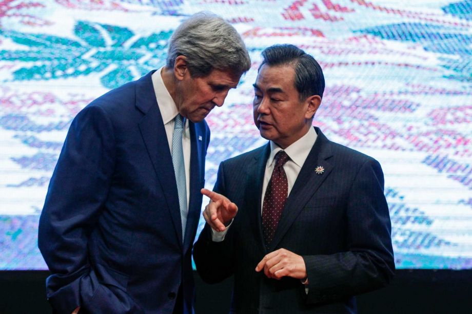 U.S. Secretary of State John Kerry left and Chinese Foreign Minister Wang Yi chat after the group