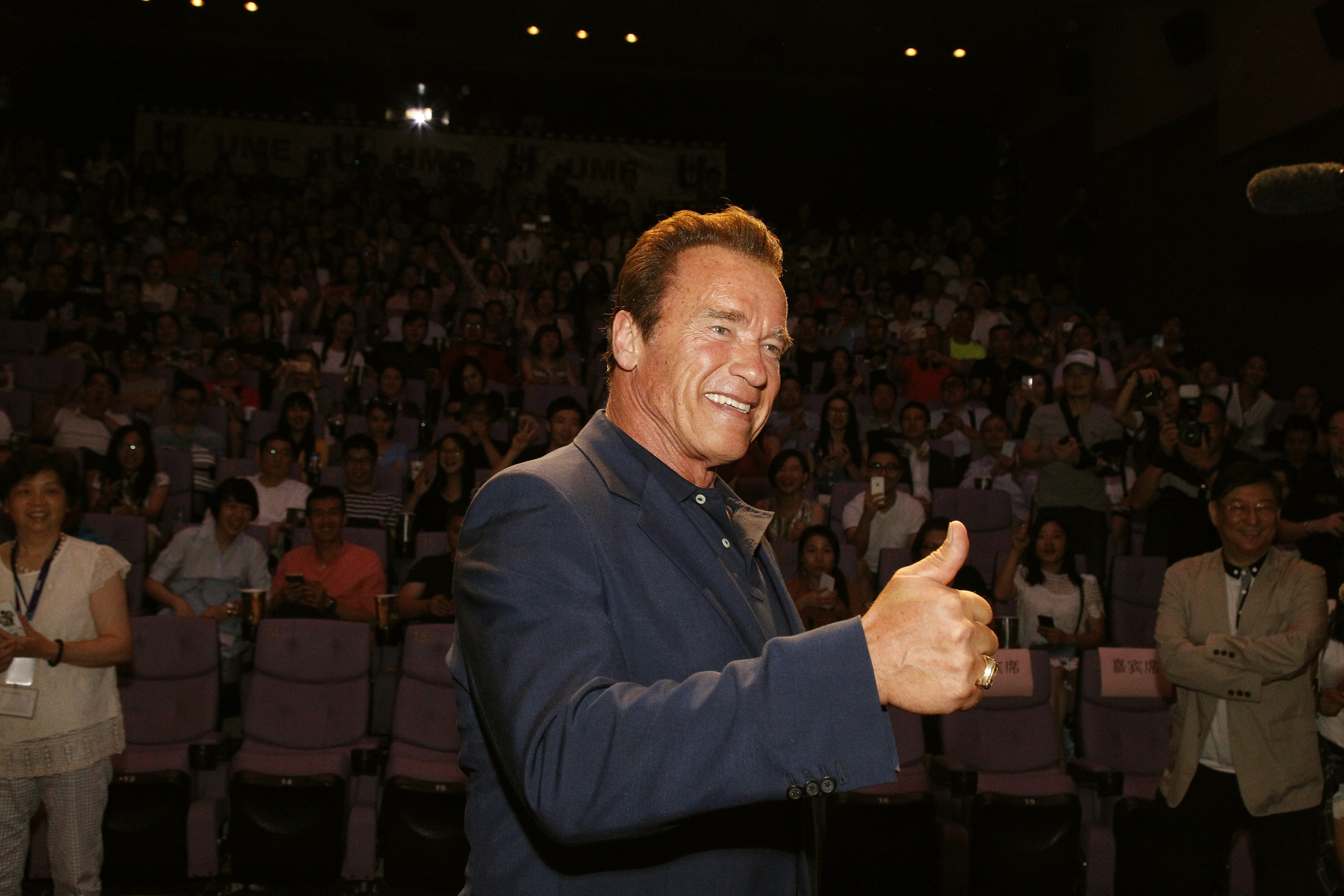 Arnold Schwarzenegger signals at a screening of the Terminator Genisys