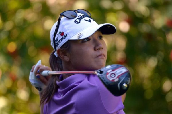 Lydia Ko of New Zealand watches her tee