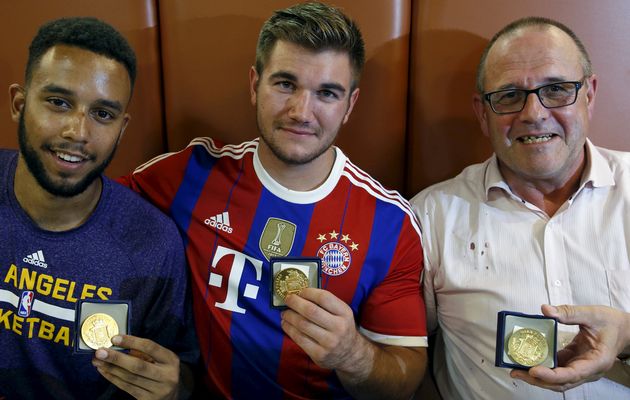 Sadler Sharlatos and Norman who helped to disarm an attacker on a train from Amsterdam to France pose with their medals at a restaurant in Arras France
A machine gun-toting attacker wounded three people on a high-speed train in France on Friday befor