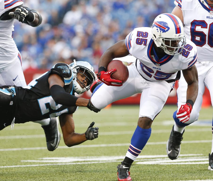 Buffalo Bills running back Le Sean McCoy is tripped up by Carolina Panthers cornerback Josh Norman during the first half of an NFL pre-season game on Friday Aug. 14 2015 in Orchard Park N.Y