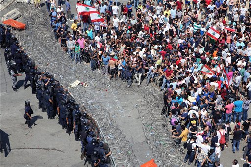 Lebanese activists clash with policemen as they try to cross to the government house during a protest against the ongoing trash crisis in downtown Beirut Lebanon