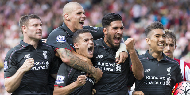 Liverpool's Philippe Coutinho lower centre left celebrates with teammates after scoring against Stoke