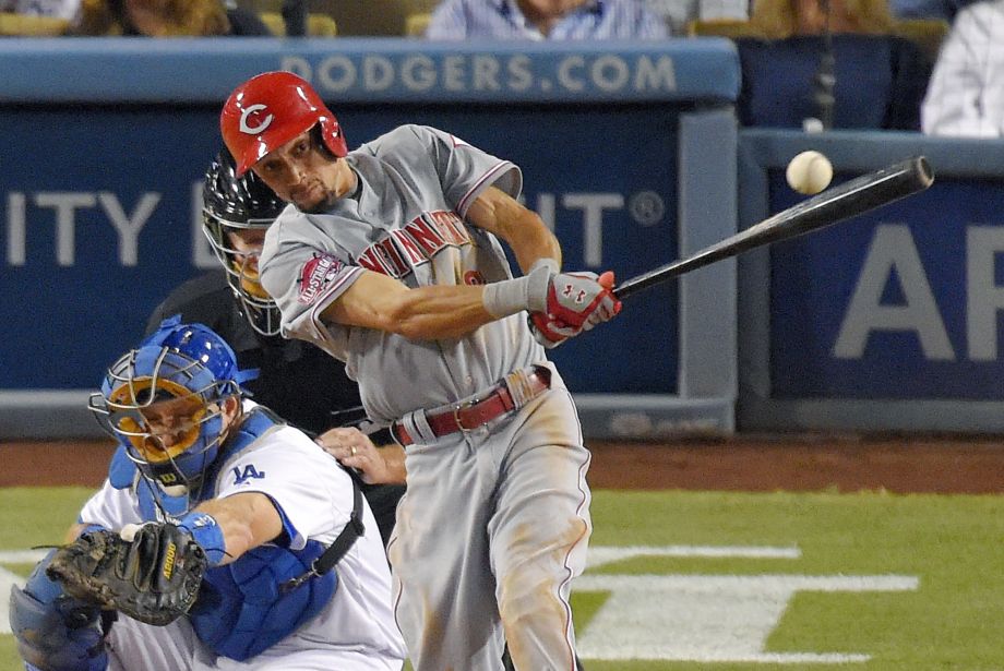 Cincinnati Reds Billy Hamilton hits a single as Los Angeles Dodgers catcher A.J. Ellis watches during the sixth inning of a baseball game Thursday Aug. 13 2015 in Los Angeles