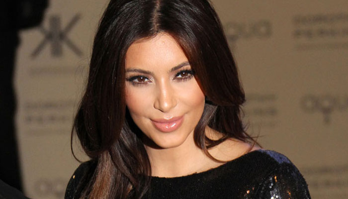 Kim Kardashian flaunts baby bump while beach workout