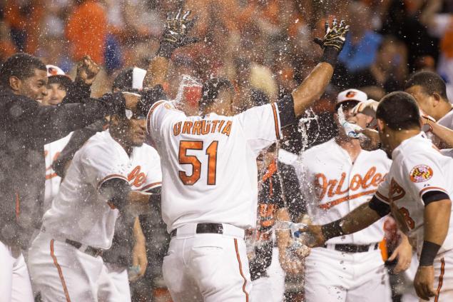 The Orioles hose down Henry Urrutia as the left fielder hits his first career home run at the perfect time