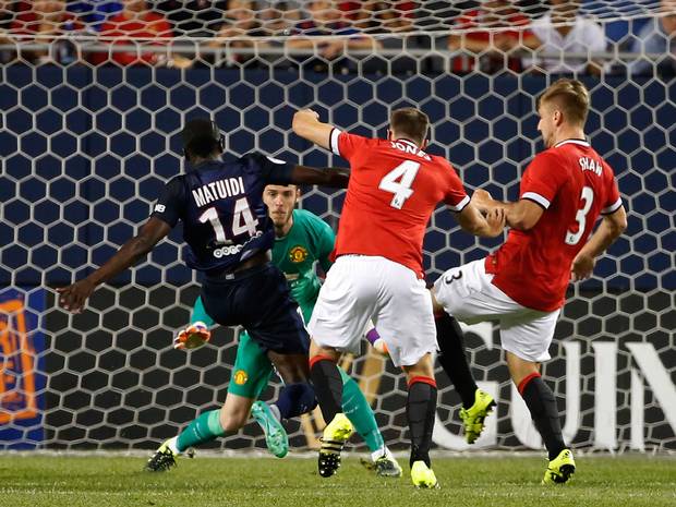 DOUBLE TROUBLE Lucas Moura No.7 of Paris Saint Germain controls the ball between Andreas Pereira No.44 and Luke Shaw No.3 of Manchester United during a match in the 2015 International Champions Cup at Soldier Field on Thursday in Chicago Illinois. AFP P