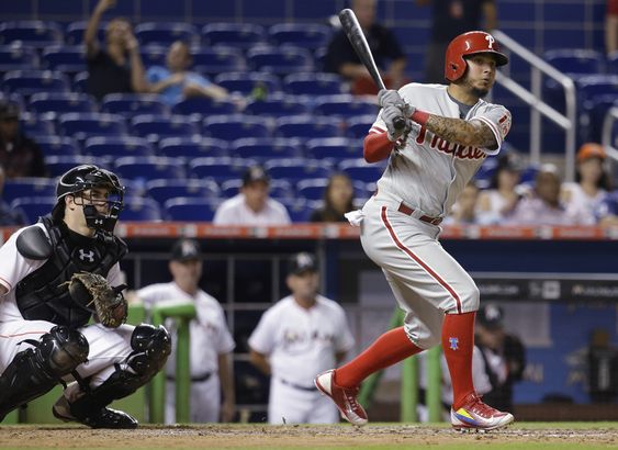 Galvis follows through on a triple that scored Aaron Altherr in the eighth inning of a baseball game against the Miami Marlins Thursday Aug. 20 2015 in Miami. At left is Marlins catcher J.T. Realmuto. The Marlins