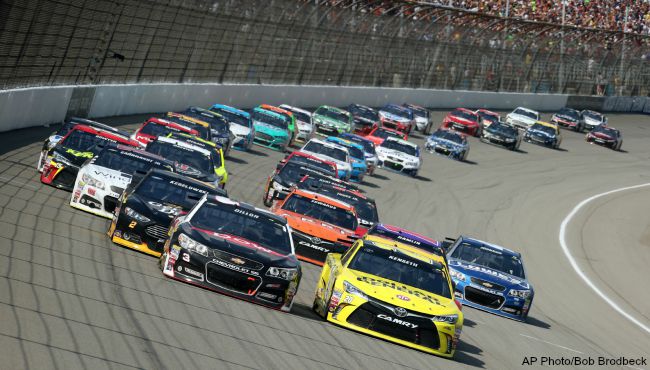 Austin Dillon left and Matt Kenseth lead the pack through the first turn during the NASCAR Sprint Cup series auto race at Michigan International Speedway Sunday Aug. 16 2015 in Brooklyn Mich