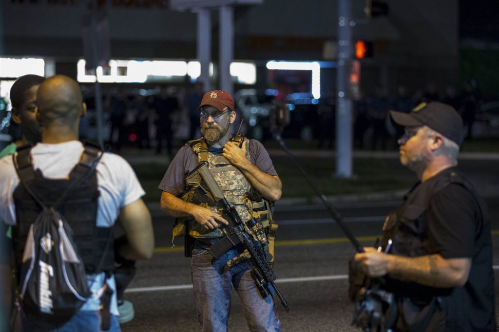 Image Members of the Oath Keepers walk with their personal weapons on the street during protests in Ferguson Missouri