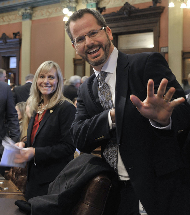 Rep. Cindy Gamrat R-Plainwell and Rep Todd Courser R Lapeer wave to reporters in the House of Representatives in Lansing. A Michigan House leader on Friday Aug. 7 2015 requested an investigation into allegations that Cour