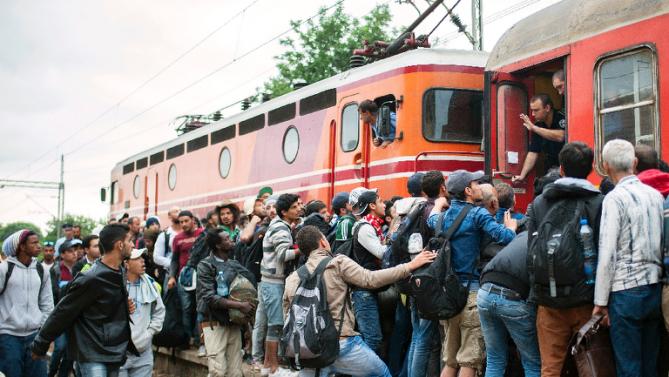 Migrants struggling to board a train to Serbia in the town of Gevgelija on the Macedonian Greek border