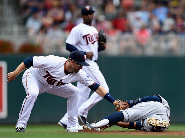 MINNEAPOLIS MN- AUGUST 16 Brian Dozier #2 of the Minnesota Twins catches Francisco Lindor #12 of the Cleveland Indians stealing second base during the first inning of the game