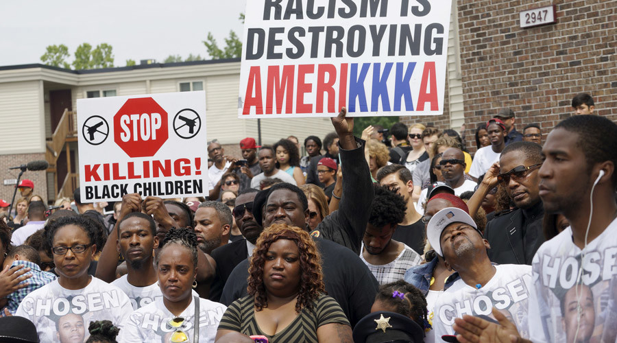 The crowd listens at an event to mark the one-year anniversary of the killing of Michael Brown in Ferguson Missouri