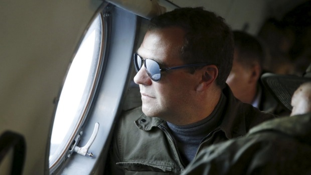 Russia's Prime Minister Dmitry Medvedev looks out a window of an aircraft during his visit to Iturup Island one of four islands known as the Southern Kurils in Russia and the Northern Territories in Japan