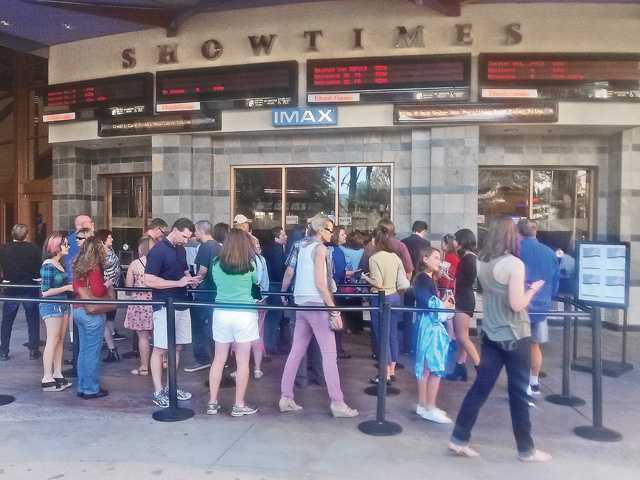 Patrons line up outside the Regal Entertainmentowned Edwards Valencia Stadium 12 back in for a showing of'Fifty Shades of Grey The theater chain has adopted the policy of searching bags and backpacks before allowing admission Signal file pho