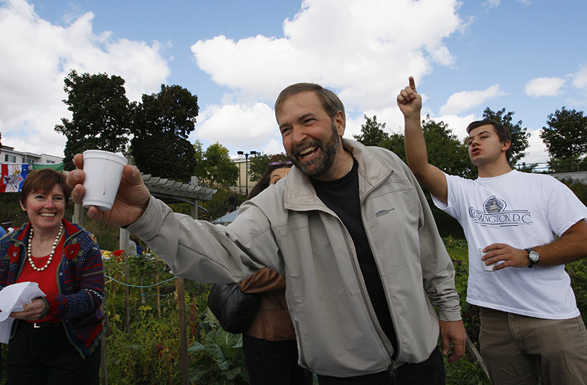 New Democratic Party candidate Thomas Mulcair greets people at a community fair while campaigning in his riding of Outremont in Montreal