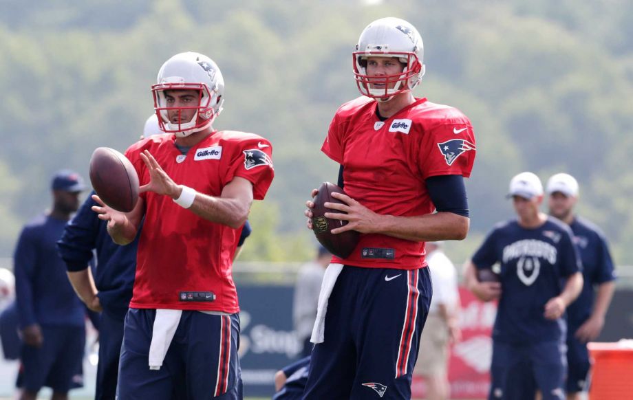 New England Patriots quarterback Tom Brady right gets set to run a drill with his back-up Jimmy Garoppolo during an NFL football training camp in Foxborough Mass. Thursday