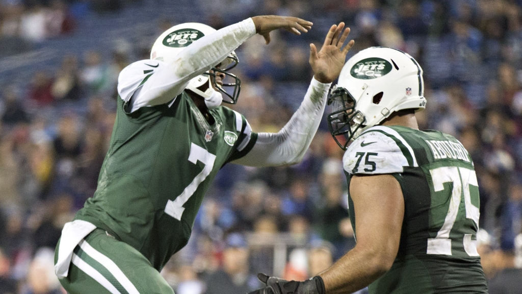 Oday Aboushi right celebrates with quarterback Geno Smith after a touchdown in the fourth quarter of a game against the Tennessee Titans at LP Field on Dec 14 2014 in Nashville Tennessee The Jets defeated the Titans