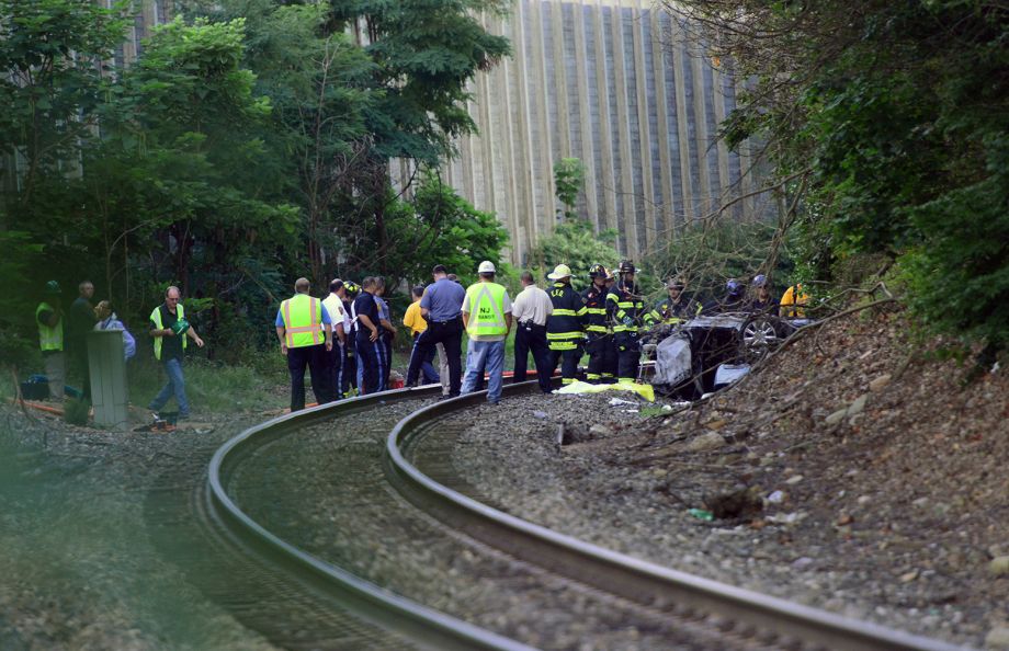 Emergency personnel work the scene of a fatal accident involving a car on the rail road tracks in Emerson N.J. Thursday Aug. 20 2015. ONLINE OUT MAGS OUT TV OUT INTERNET OUT NO ARCHIVING MANDATO