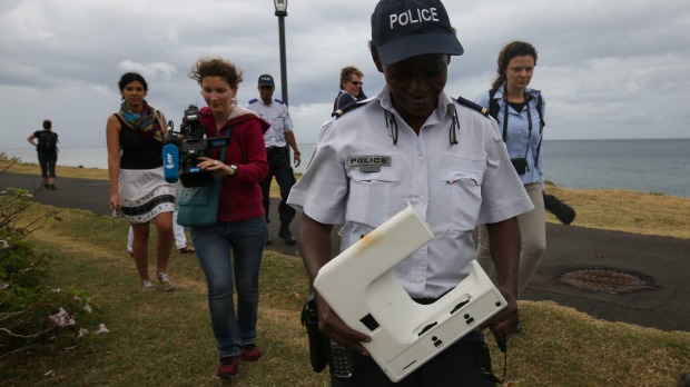 National Police Brigadier Gisele Cadar carries the plastic beach debris away from St Denis beach Reunion Island on Tuesday