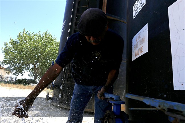 Joe Ben Jr. Shiprock Chapter House Farm Board representative touches the water from a tank in Shiprock N.M. The quality of San Juan River water on the Navajo Nation has returned to what it was before a spill at a Colorado