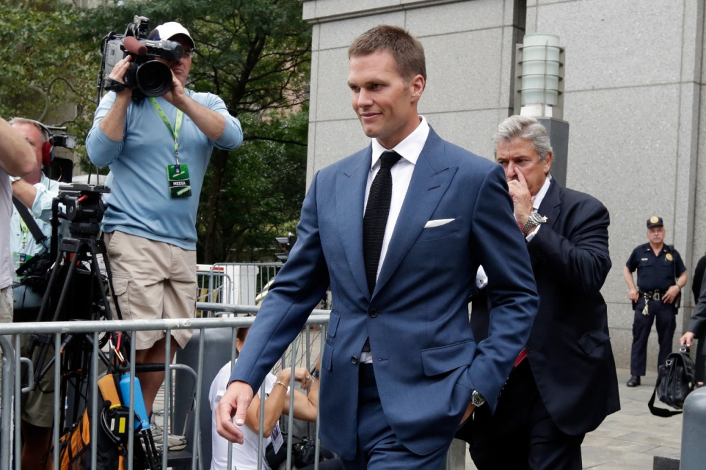 New England Patriots quarterback Brady steps off the team's charter flight as they arrive in Indianapolis