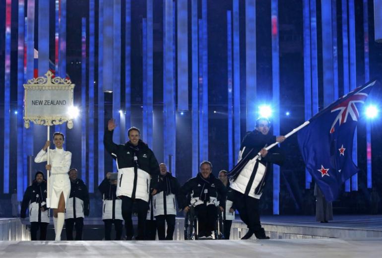 New Zealand's flag-bearer Adam Hallflag, leads his country's contingent during the opening ceremony of the 2014 Paralympic Winter Games in Sochi